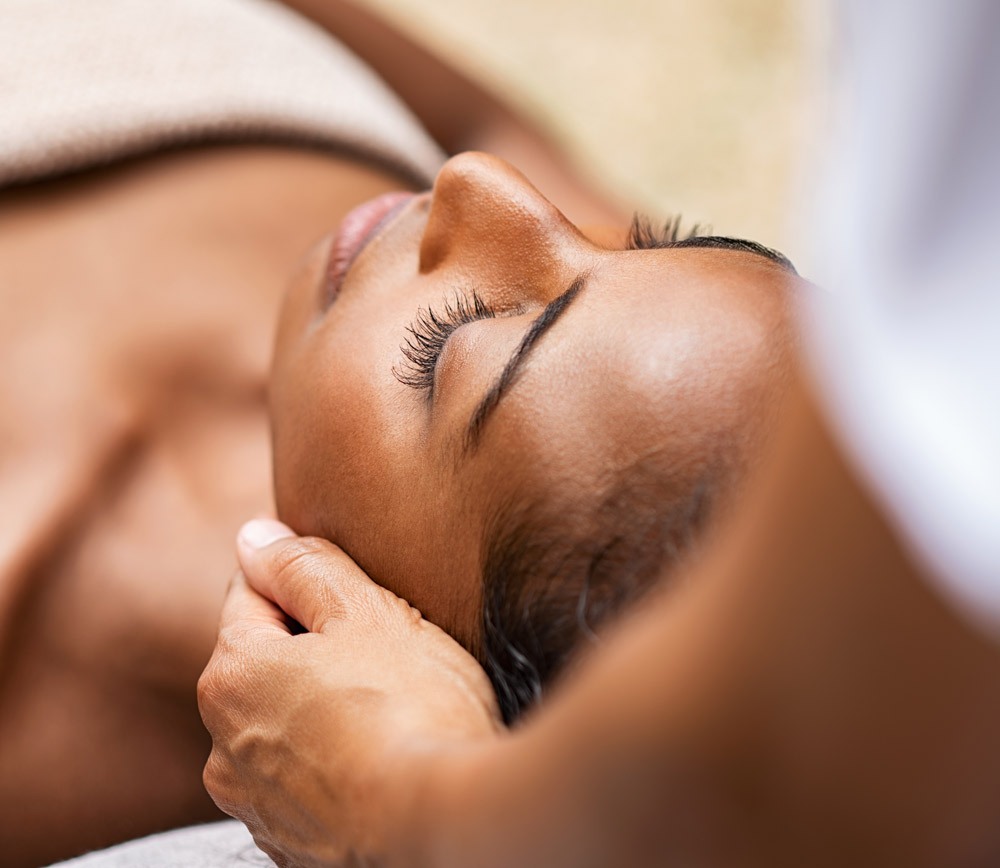 Black woman getting head massage and facial Black woman getting head massage and facial